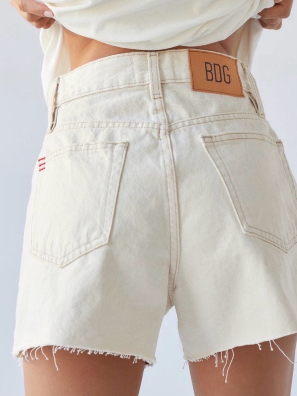BDG High-Rise Raw Hem Cream Denim Shorts